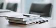 © kwanchaift - Clean, minimalist shot of a clean, simple stack of notebooks and a few pens on a clean table before the meeting starts, preparation, anticipation, clean design, 16K,