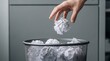 © Yassine - Close up of a hand tossing a wadded up piece of paper into a metal wastebasket full of discarded ideas