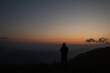 © Natalia - Sunset in the mountains. Silhouette of a man on a dark background of nature while traveling.