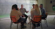© Marco - Therapy group session with diverse individuals seated in circle, participants sharing and listening during guided emotional support meeting indoors