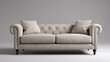 © Thiago - An elegant beige sofa with two throw pillows, perfect for any living room or lounge area. The sofa showcases detailed button tufting and rolled arms, and a classic design
