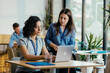 © Suteren Studio - Two Female Startup Team Members Preparing Pitch Presentation Notes at Conference Venue Cafe