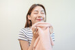 © Pormezz - Asian housewife smelling freshness scent of clean clothes