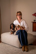 © sepy - Blond haired woman with her dogs relaxing at home