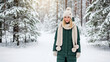 © Tegar Ramadhani - Young woman in winter clothing walking through a snowy forest