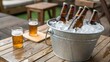 © NoorArt Studio - Beer bottles chilling in ice bucket with glasses nearby