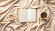 © NoorArt Studio - Cozy overhead view of an open book and coffee on blanket