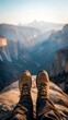 © NoorArt Studio - First person view of hiking boots overlooking a vast canyon