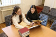 © Vasyl - Two women in the library are choosing books to read.