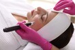 © New Africa - Woman undergoing microneedling procedure in beauty salon, closeup