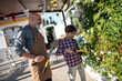 © Antonio Recena - Grandfather and grandson pruning jasmine plant at spanish garden