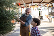 © Antonio Recena - Grandfather and grandson: The 60-year-old man prunes the olive tree while his 10-year-old grandson watches.