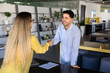 © fizkes - Cheerful young Latin businessman giving handshake to co-worker