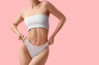 © Pixel-Shot - Young woman in underwear on pink background. Liposuction concept