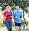 © Lumos sp - Smiling active mature senior couple jogging together in the park