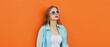 © rohappy - Portrait of modern stylish young woman in white glasses, casual clothing posing on orange background