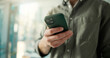 © peopleimages.com - Man, hands or scroll in office with phone for social media insights, marketing campaign or project. Space, person and research with tech in workplace for digital advertising, SEO report or creativity