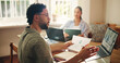 © peopleimages.com - Home, conversation and couple with laptop, documents and checklist for financial income. Bills, man and woman with computer, mortgage or feedback for budget, taxes and charts for retirement funding