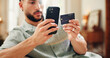 © peopleimages.com - Credit card, purchase or man on sofa with phone, online banking or payment in eft transaction. Serious, easy transfer or male person at house with tech, remote or debit details for cashless service.
