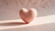 © ROWSHAN - Knitted pink heart on a soft background with sunlight