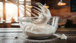 © 현욱 김 - Close up of silver whisk creating stiff meringue peaks in a glass bowl
