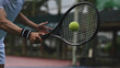 © saltdium - A tennis player swings the racket toward a fast-moving ball, captured in a dynamic close-up action shot on the court