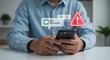 © Shams - Mobile phone security breach: Person receiving suspicious message and fraud alert on smartphone, concept of online safety and identity theft prevention