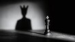 © Oleksandr - A king chess piece casts a shadow of a king wearing a crown in this dramatic, monochrome shot. The composition symbolizes ambition, power, and the game of strategy.