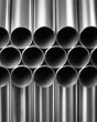 © by.anastasiya - Hollow aluminum tubes arranged in a vertical geometric stack shown in a clean close-up view.