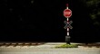 © Alexandr - Stop sign at a quiet railroad crossing beside empty tracks and gravel under dark sky