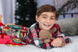 © Tamara Sales  - cute little boy on a bed in holiday pjs 8 years old 7 years old with teddy bear