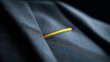 © perfectlab - Close-up of dark fabric with detailed texture and a single bright yellow stitch highlighting contrast and fine craftsmanship in textile design