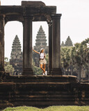 Female Traveler Framed By Columns At Angkor Wat, Cambodia Travel Editorial