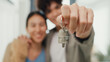 © tirachard - Close-up Young happy Asian sweet couple hug each other smiling looking at camera so proud show off new house keychain in living room. Husband wife move new home, Apartment Rent And Ownership Concept.