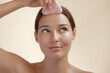 © Buyanskyy Production - Skincare Concept With Woman Massaging Forehead Using Pink Gua Sha Tool