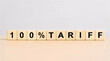© Tejas Designs - 100% Tariff Concept on Wooden Blocks – Trade Protection, Import Duty and Tax Increase Symbol on Neutral Background for Economics, Finance, Policy, Business and Inflation Topics