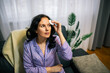 © Mediteraneo - Middle-aged woman cleansing face with cotton pad