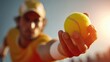 © dmmarychev - Tennis player holding a bright yellow ball high up against a sunny blue sky