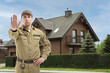© New Africa - Security guard for private property protection. Man in uniform blocking way to house outdoors
