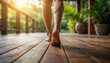 © -Y4NN- - pieds et jambes d'une femme marchant sur une terrasse extérieure en bois