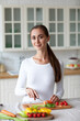 © BestForYou - Woman in the kitchen chops vegetables, prepares healthy food, proper nutrition