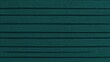 © buraratn - Textured dark teal fabric background with horizontal lines creating depth and dimension for creative projects and backgrounds in various applications