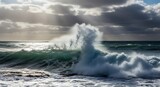 Powerful Ocean Wave Crashing Against Rocks with Dramatic Sky, Coastal Scenery, and Natures Fury.