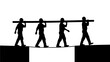 © Paul Studio - Four men in silhouette carrying a long pole across a gap on a bridge