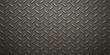 © Alpha Designs - A seamless gray industrial diamond plate texture creates a rough metallic steel surface pattern for a silver aluminum sheet material wallpaper suitable for a construction industry background