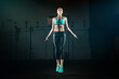© peopleimages.com - Exercise, woman and jump with rope in gym for cardiovascular fitness, training and health. Skipping, athlete and person with workout for wellness in club, energy and burn calories for endurance