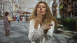© Krakenimages.com - Woman doctor in white coat with stethoscope blows a kiss, hand to lips gesture on a busy street market; affectionate farewell.