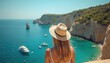 © miss irine - Woman in straw hat gazes at azure Mediterranean Sea, yachts float on blue water near rocky coast. Rich green cliffs rise above clear turquoise bay. Sunny sky, summer vacation vibe.