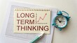 © Mahathir - Long Term Thinking Concept with Graph, Alarm Clock, Notepad and Pen Showing Business Strategy and Planning Importance