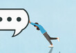 © fStop - Woman resisting, pushing dot dot dot symbol inside large speech symbol against blue background